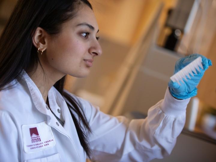 A student examines pipette tray